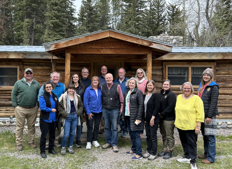 Image of group in front of cabin